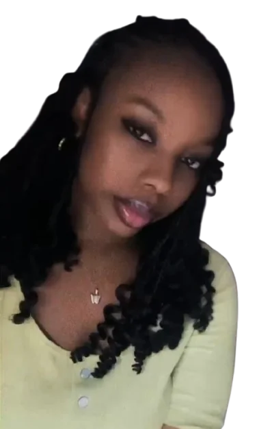 Woman with long curly braids wearing a light green top