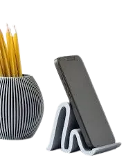 Smartphone resting upright on a grey wave-shaped phone stand, next to a ribbed holder filled with pencils